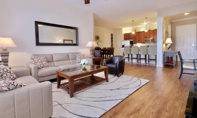 a living room with a couch and a table at WOW Upscale Penthouse in Orlando