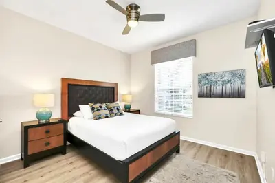 a bedroom with a bed and a ceiling fan at Lake & Pool View Fireworks in Orlando