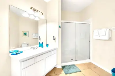 a bathroom with a white sink and a shower at Lake & Pool View Fireworks in Orlando