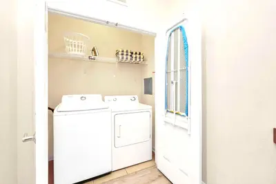 a white laundry room with a washer and dryer at Lake & Pool View Fireworks in Orlando