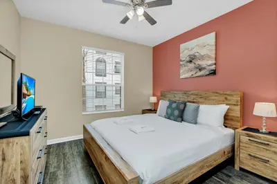 a bedroom with a bed and a flat screen tv at Totally Remodeled Beauty WOW in Orlando