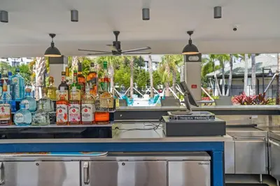 a bar with a lot of bottles of alcohol at Totally Remodeled Beauty WOW in Orlando