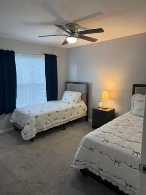 a bedroom with two beds and a ceiling fan at Luxury house in Disney in Kissimmee