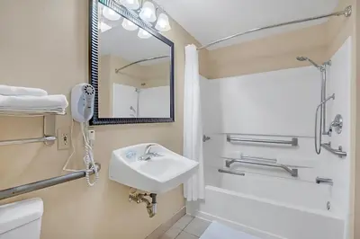 a bathroom with a sink and a mirror at Stylish King Apt w Arcade Game & BBQ Near Disney in Orlando