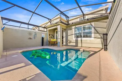 a swimming pool in the backyard of a house at Gorgeous 5Bd w Pool & Lazy River at Storey Lake 4989 in Kissimmee