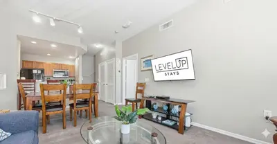 a living room and dining room with a table at Disney 8mi Heated Resort Pool Hot Tub Fitness in Kissimmee