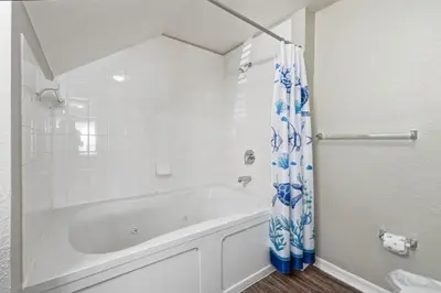 a white bathroom with a tub and a shower at Disney 8mi Heated Resort Pool Hot Tub Fitness in Kissimmee