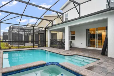 a swimming pool in front of a house at 9 MI to Disney w Pool Cinema & FREE Waterpark in Kissimmee