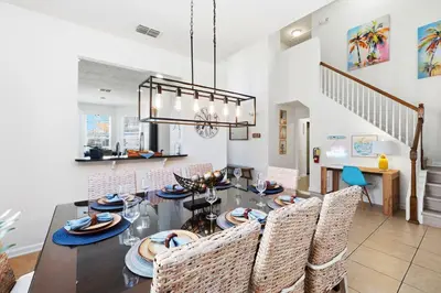 a dining room with a table and chairs at Disney Family Escape - Stunning 5-Bed Villa with Private Pool in Orlando