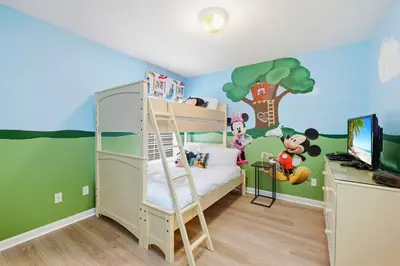 a bedroom with a bunk bed with mickey mouse mural at Disney Family Escape - Stunning 5-Bed Villa with Private Pool in Orlando