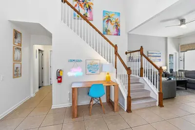 a home office with a desk and stairs at Disney Family Escape - Stunning 5-Bed Villa with Private Pool in Orlando