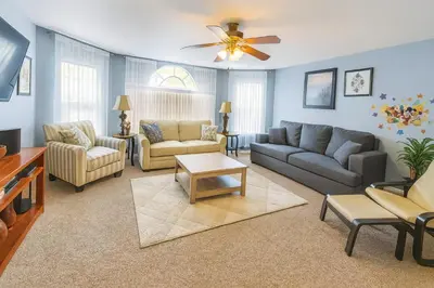 a living room with couches and a ceiling fan at Disney Magic Condo 1st Flr 3BR Disney-Themed Pool in Kissimmee