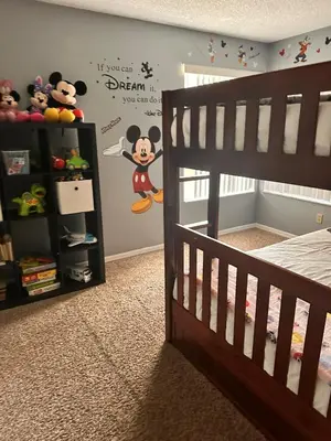 a bedroom with a mickey mouse decal on the wall at Disney Magic Condo 1st Flr 3BR Disney-Themed Pool in Kissimmee