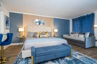 a bedroom with a king sized bed and a couch at Studio with Private Terrace and Volcano Bay View Near Epic Universe in Orlando