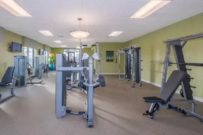 a gym with several tread machines in a room at Spacious Villa w Pool Slides and Lush Nature Views in Kissimmee