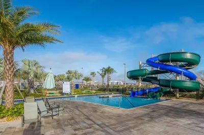 a water slide at a resort with a pool at Spacious Villa w Pool Slides and Lush Nature Views in Kissimmee