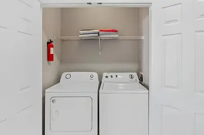 two whitewashes in a small kitchen with white cabinets at Apartamento 3Q Vista Cay c/ Varanda e Jogos in Orlando