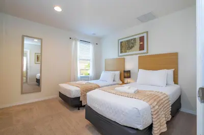 a hotel room with two beds and a mirror at Cozy 2 bedrooms with Hot tube in Kissimmee