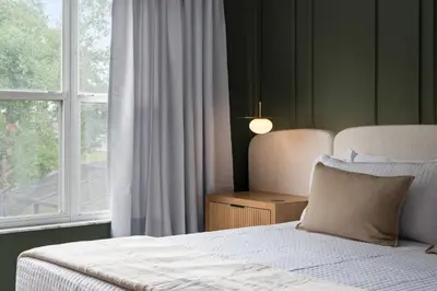 a bedroom with a bed next to a window at 10min to Disney, Luxury 6BR Themed Villa with Private Pool,Spa and Game Room in Orlando