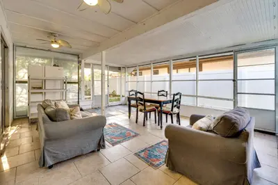 a living room with two couches and a table at 3 Mi to SeaWorld! Suburban Home with Screened Porch in Orlando