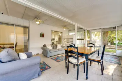 a living room with a table and a couch at 3 Mi to SeaWorld! Suburban Home with Screened Porch in Orlando