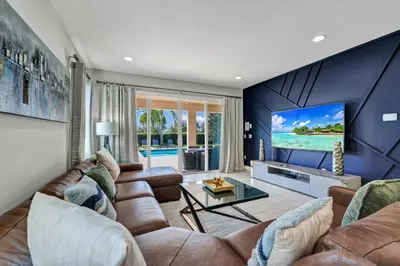 a living room with a couch and a tv at Fun-Filled Getaway With Private Pool, Theme Rooms & Game Room And Waterpark Access Near Disney At Encore Resorts Reunion - 7604Mc in Orlando