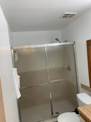 a bathroom with a shower and a toilet at Ortona's Best Kept Secret Three-Two Spacious Home in Orlando