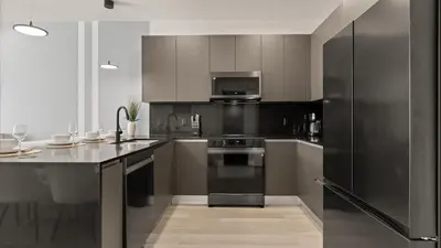 a kitchen with black appliances and a counter top at Stunning Townhome with Private Pool & Games Room in Orlando