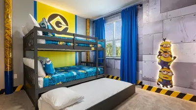 a childs bedroom with a bunk bed and blue and yellow walls at Stunning Townhome with Private Pool & Games Room in Orlando