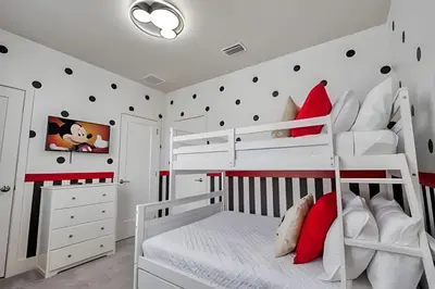 a white bedroom with red and white bunk beds at Casa 4Q Hidden Forest c/ Piscina in Orlando