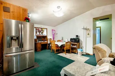 a kitchen and dining room with a stainless steel refrigerator at Red brick house in Kissimmee