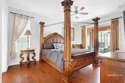 a bedroom with a canopy bed and a table at Family Retreat near Disney with Private Pool in Kissimmee