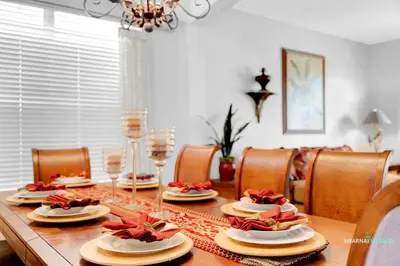 a dining room table with plates and wine glasses at Family Retreat near Disney with Private Pool in Kissimmee
