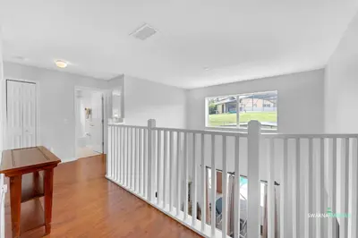 a white room with a staircase with a window at Family Retreat near Disney with Private Pool in Kissimmee