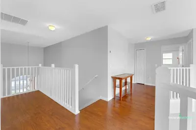 a white room with a staircase and a table at Family Retreat near Disney with Private Pool in Kissimmee