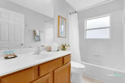 a white bathroom with a sink and a toilet at Family Retreat near Disney with Private Pool in Kissimmee