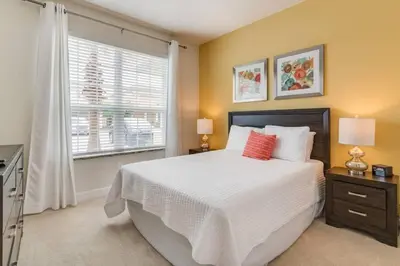 a bedroom with a large bed and a window at Casa 3Q Serenity c/ Piscina – Perto da Disney in Orlando