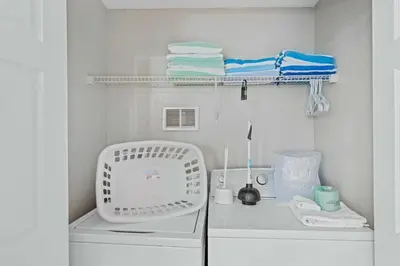 a white laundry room with a sink and towels at Townhouse Moderno 3 Quartos no Vista Cay Resort in Orlando
