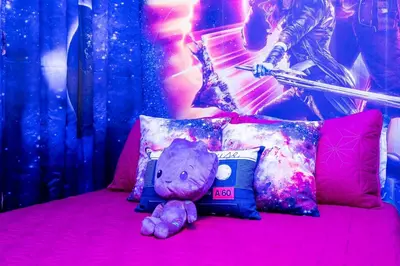 a purple teddy bear sitting on a pink bed at Enchanting 6BR, Themed Rooms, Game Room and Resort in Kissimmee