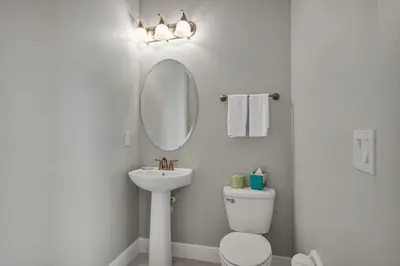a bathroom with a sink and a mirror and a toilet at Spacious Fun Retreat With Private Pool And Game Room Near Disney And Waterpark & Resort Access At Encore Resorts Reunion - 7659Wi in Orlando