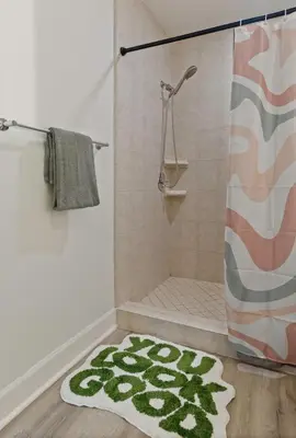 a bathroom with a shower and a rug at Kissimmee Retreat with Jacuzzi and Games in Kissimmee
