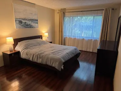 a bedroom with a bed and a large window at Residence near trails, shopping in Orlando