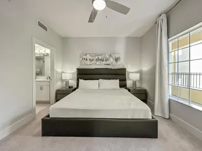 a bedroom with a large bed and a window at Family-Friendly 3-Bedroom Condo for 6 and 5 min to Disney in Orlando