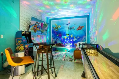 a room with a bowling alley with an aquarium at Fun Family Villa Pool BBQ Near Disney World in Kissimmee