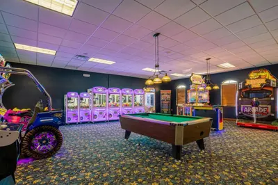 a gaming room with a pool table and arcade machines at Fun Family Villa Pool BBQ Near Disney World in Kissimmee