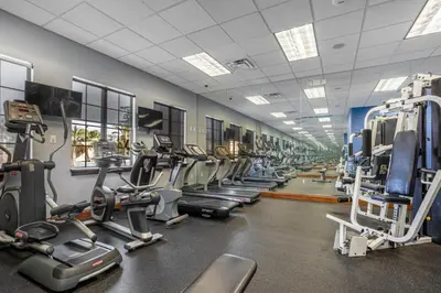 a gym with a lot of treadms and machines at Fun Family Villa Pool BBQ Near Disney World in Kissimmee