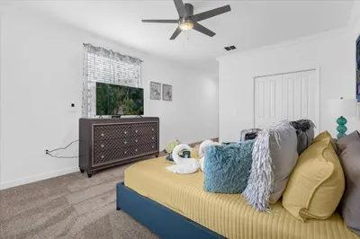 a living room with a couch and a flat screen tv at Disney Escape Villa Pool Resort Amenities in Kissimmee