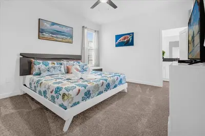 a bedroom with a bed with a swan on it at Disney Escape Villa Pool Resort Amenities in Kissimmee