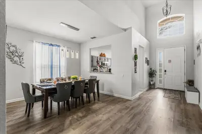 a dining room with a table and chairs at Large Family Retreat Pool BBQ Disney Parks Nearby in Orlando