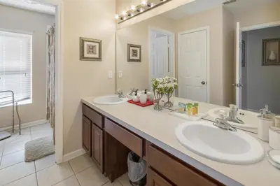 a bathroom with two sinks and a large mirror at Bright Resort Home Pool Near Disney in Orlando